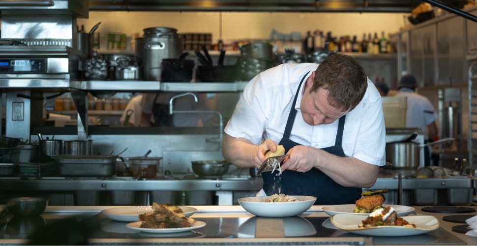 Home Block Restaurant at Cedar Creek's Executive Chef Neil Taylor personally preparing dishes in their open-concept kitchen