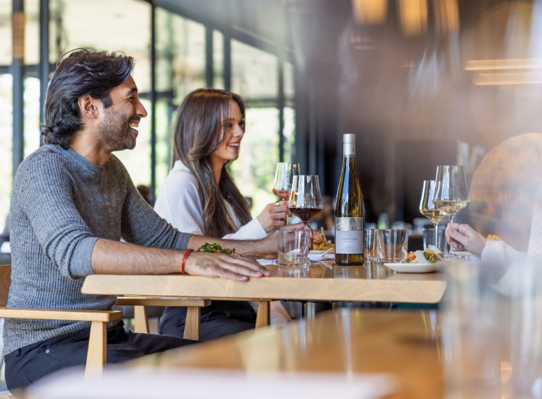 A group enjoying an intimate dining experience inside Home Block Restaurant at Cedar Creek paired with Platinum tier wines