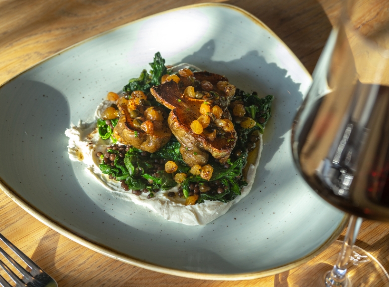 Home Block Restaurant's local braised greens served with Cedar Creek Estate Winery's Platinum Pinot Noir