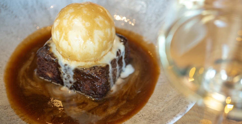 Home Block Restaurant's signature sticky toffee pudding dessert served with Platinum white wine